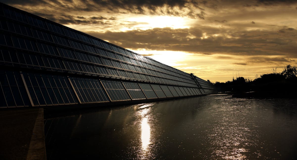 Solar panel array near coastline showing the salt-air environment equipment must withstand in Hawaii