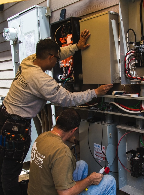 AEI licensed electricians working on an electrical panel upgrade